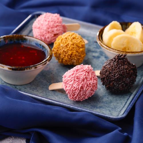 Bonbon ice cream with raspberry sauce and banana slices