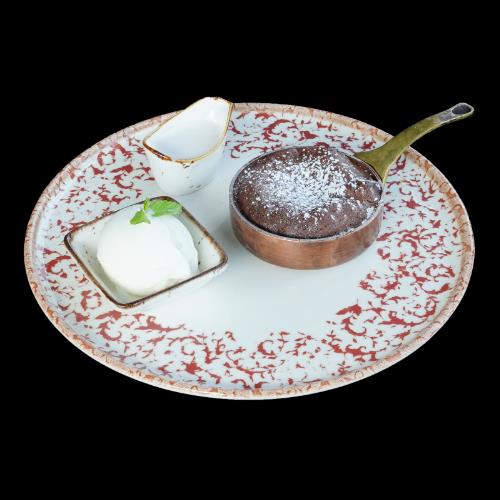 Dark chocolate soufflé with cream and vanilla ice cream