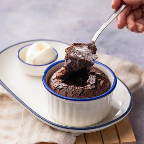 Chocolate soufflé with plain ice cream and powdered sugar