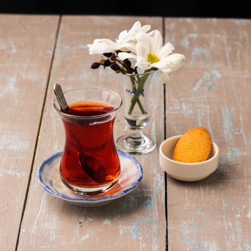 Brewed Turkish tea (glass cup) with cake or cookie