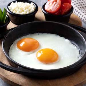 Eggs cooked in a pan with butter