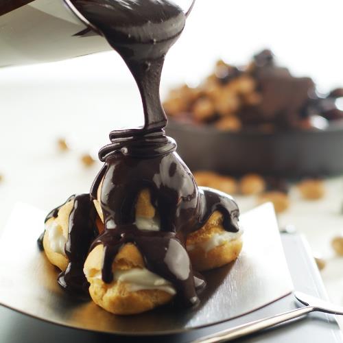 Chocolate profiteroles with powdered pistachio
