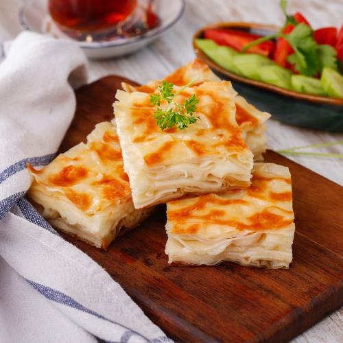 White cheese su böreği with cherry tomatoes and Çengelköy cucumber